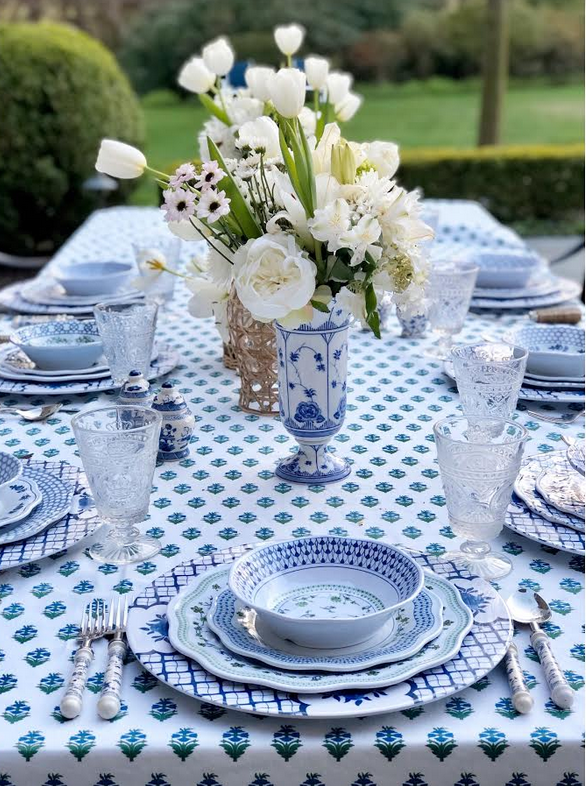 Setting a blue and white outdoor table….